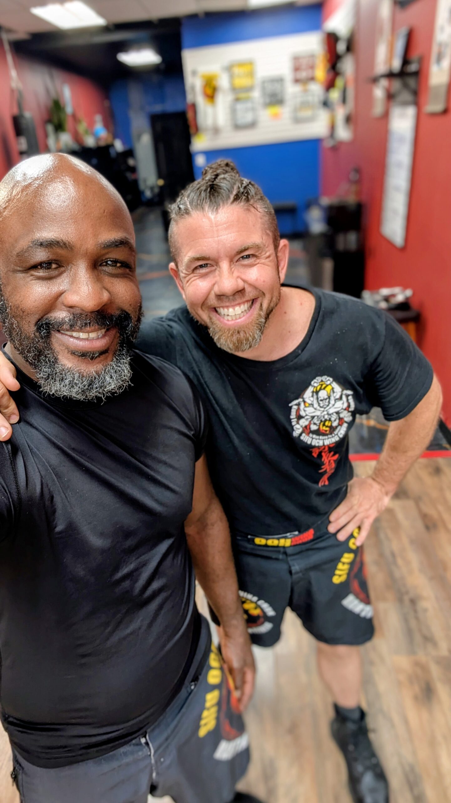 Sifu Och and Sifu Garret standing together in black Sifu Och Wing Chun shirts at Tampa Wing Chun Kung Fu